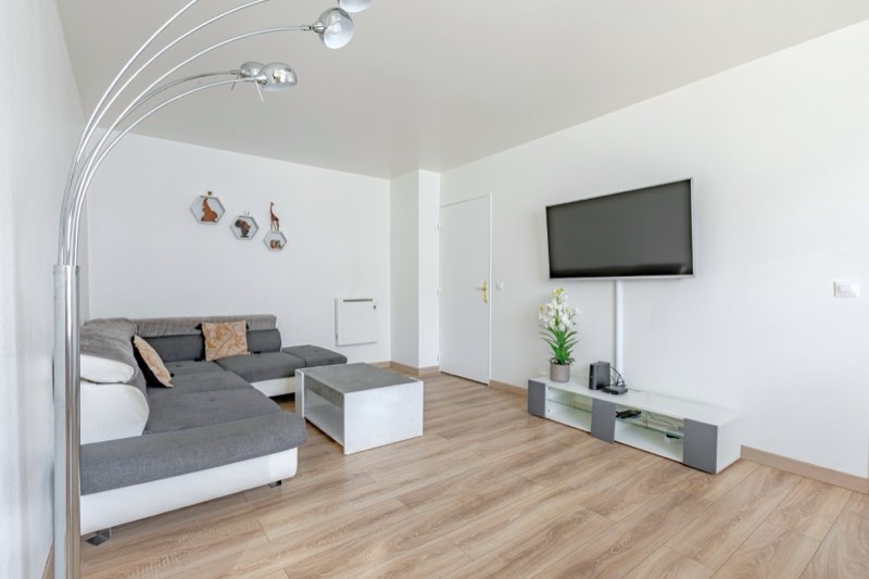 Living room of the apartment in La Plaine Saint-Denis with corner sofa and large TV